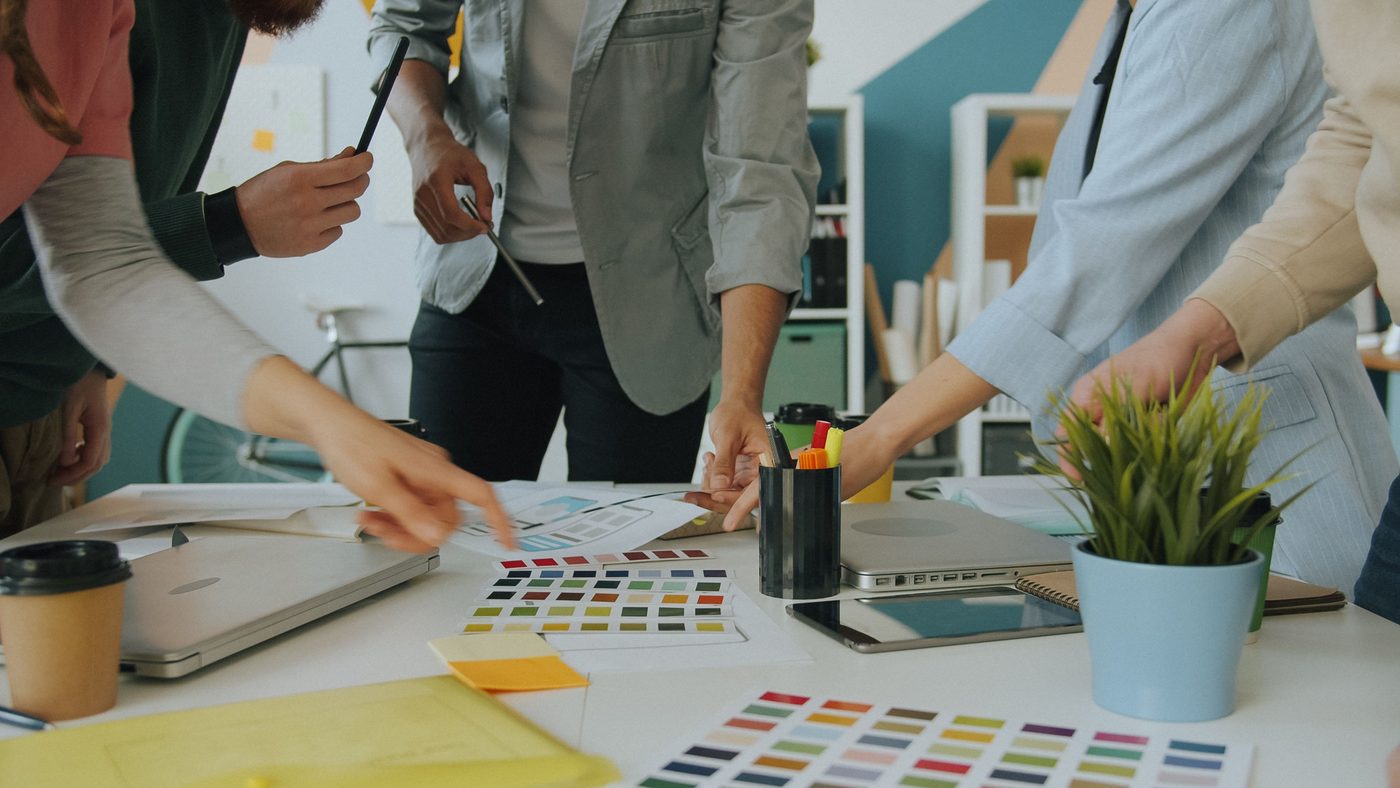 A creative team reviewing colour swatches at a studio table